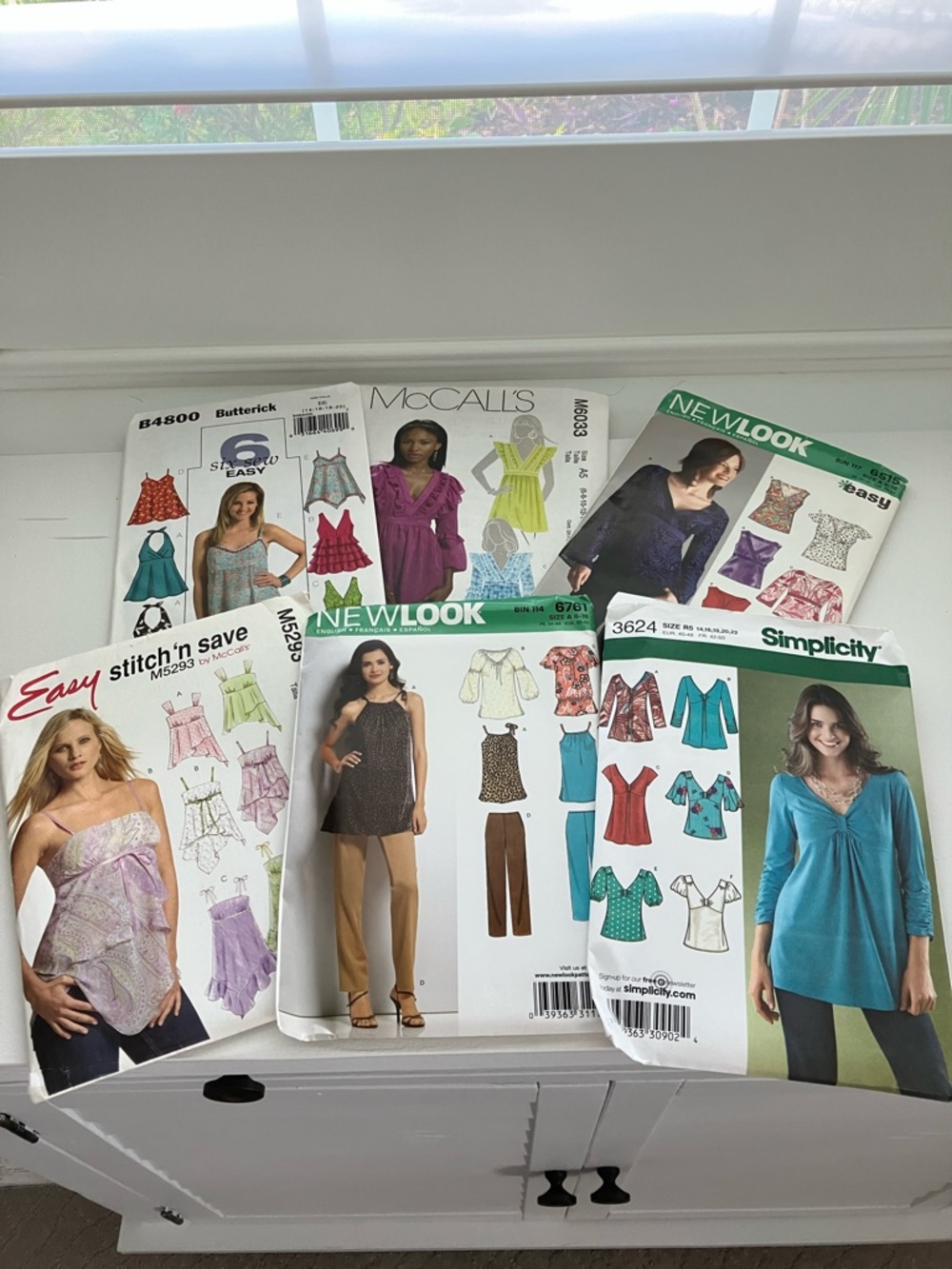 Six uncut sewing patterns adult women’s tops sizes 6–22